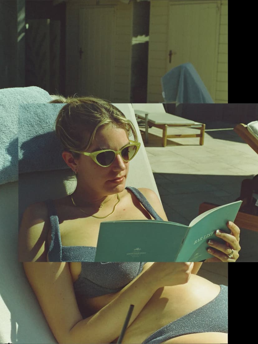 a woman in a bikini is reading a book called marine
