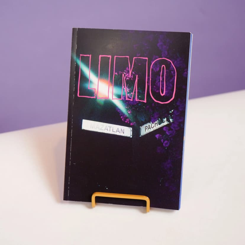 a book is sitting on top of a table with a purple background .