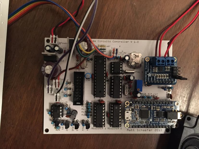 a circuit board with a lot of wires connected to it is sitting on a wooden table .