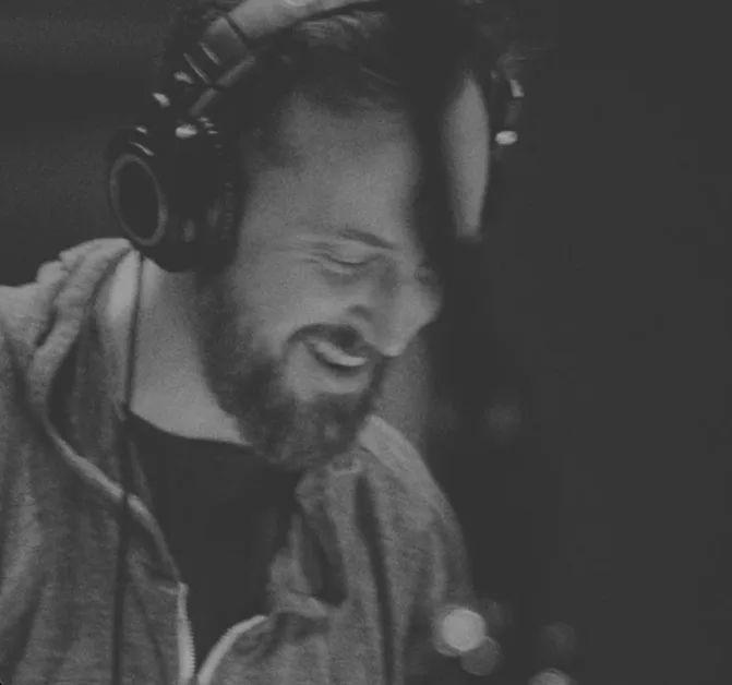 a black and white photo of a man wearing headphones