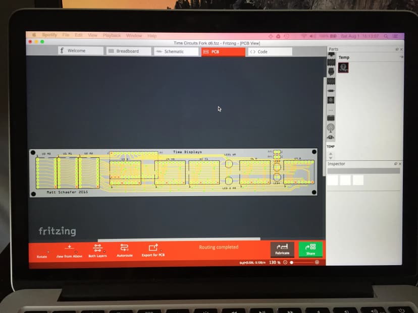a laptop computer is open to a program called fritzing .