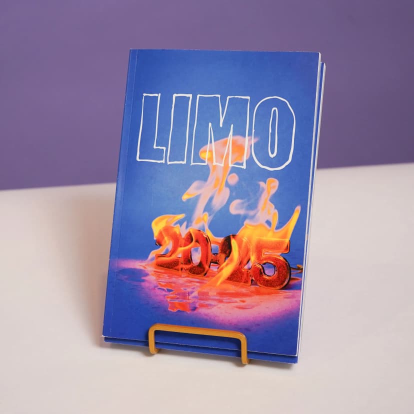 a blue book is sitting on top of a purple table .