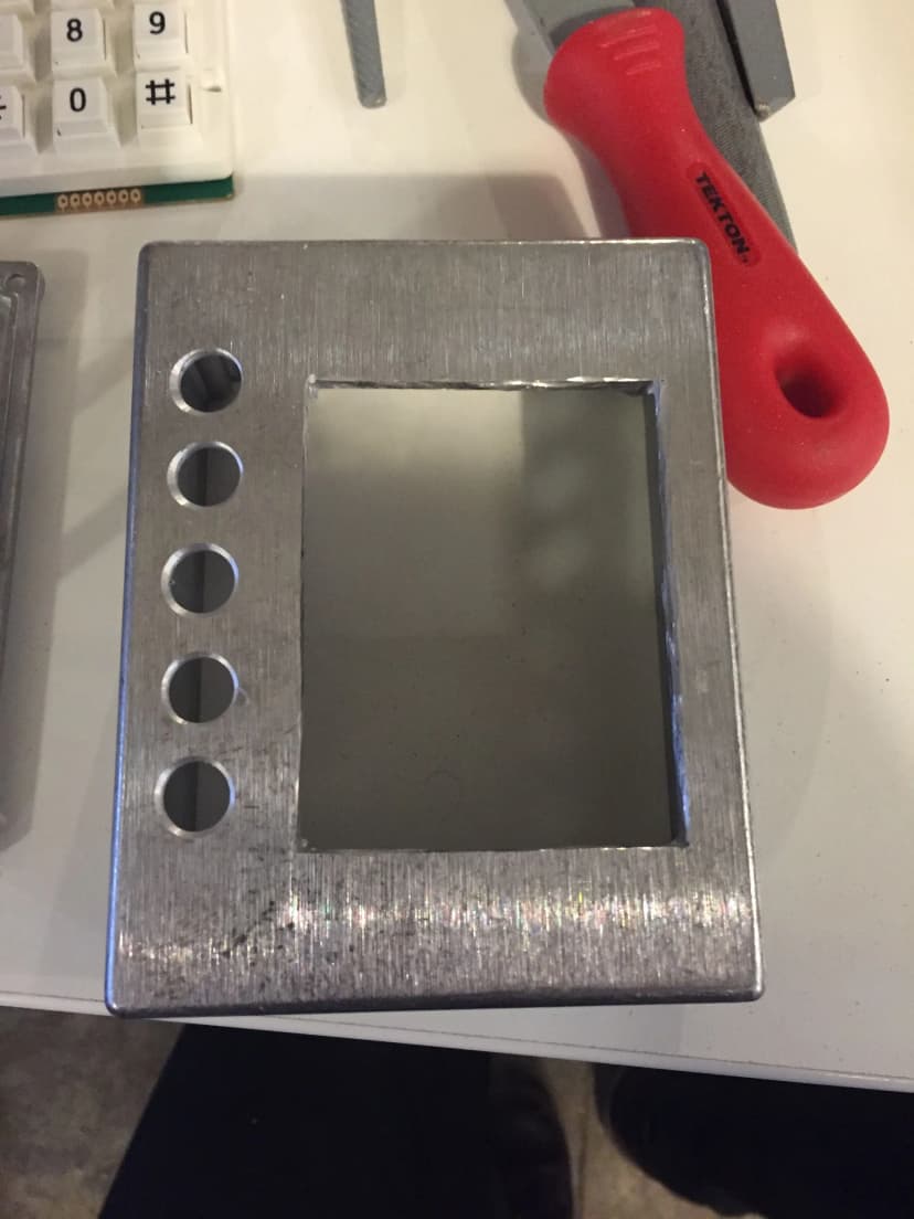 A metal box, drilled out for electronics