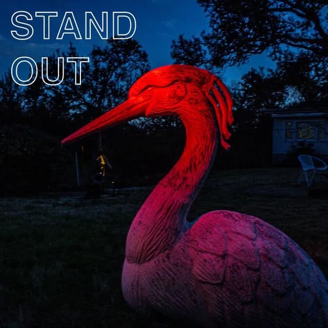 a statue of a bird with the words stand out above it