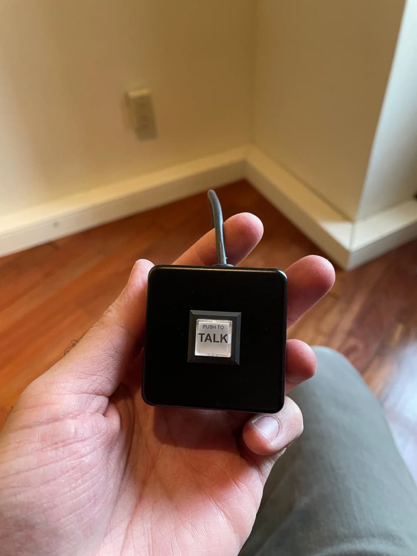 a person is holding a small device that says talk on it
