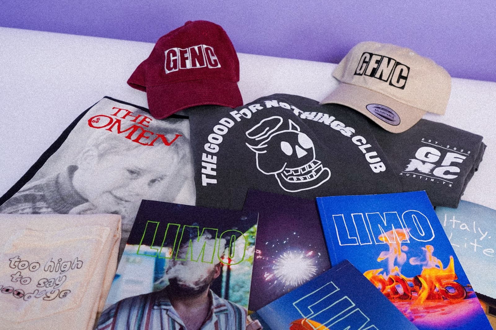 GFNC hats, club t-shirts, LIMO magazines, and member-made merch laid out on a table