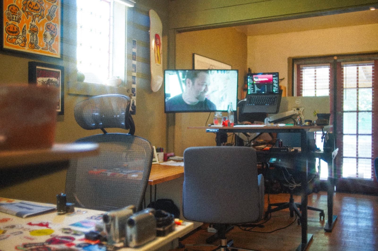 Desks with monitors and task chairs in the shared workspace at the clubhouse